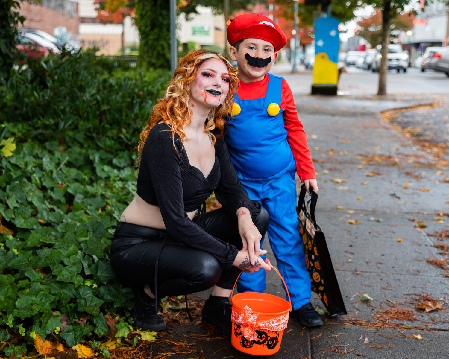 Raven Macklin and Josiah Montelongo, 6, pose for a photo in downtown Centralia while trick-or-treating on Halloween.