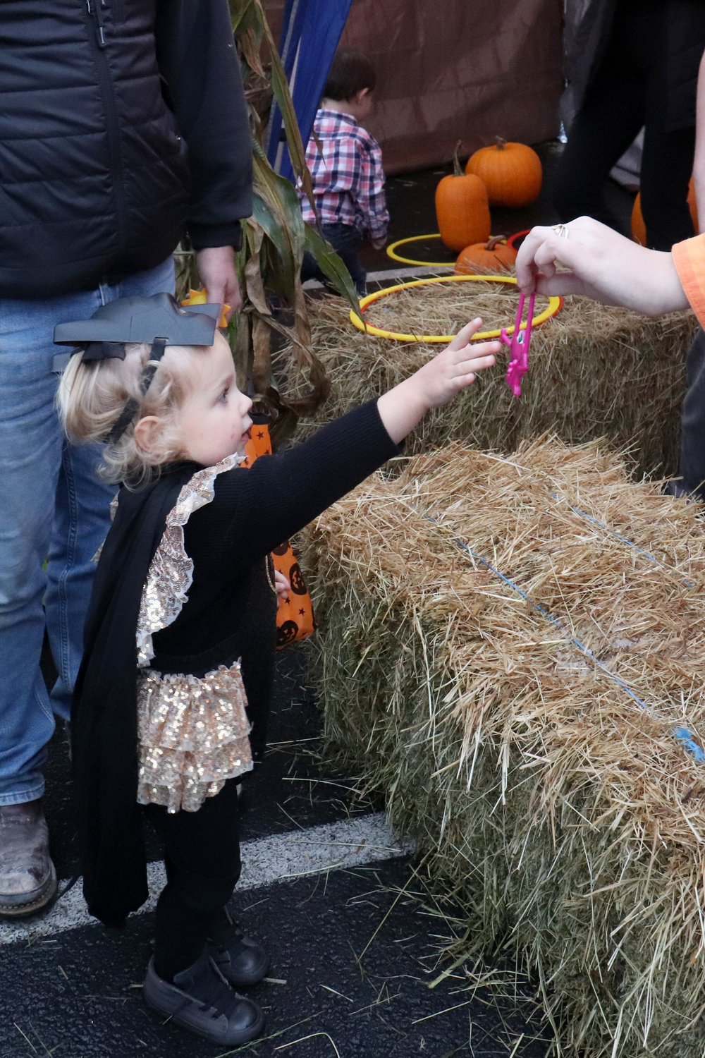 Reese accepts a prize after playing a bean bag toss game at Napavine Assembly of God Church’s trunk or treat event on Monday.