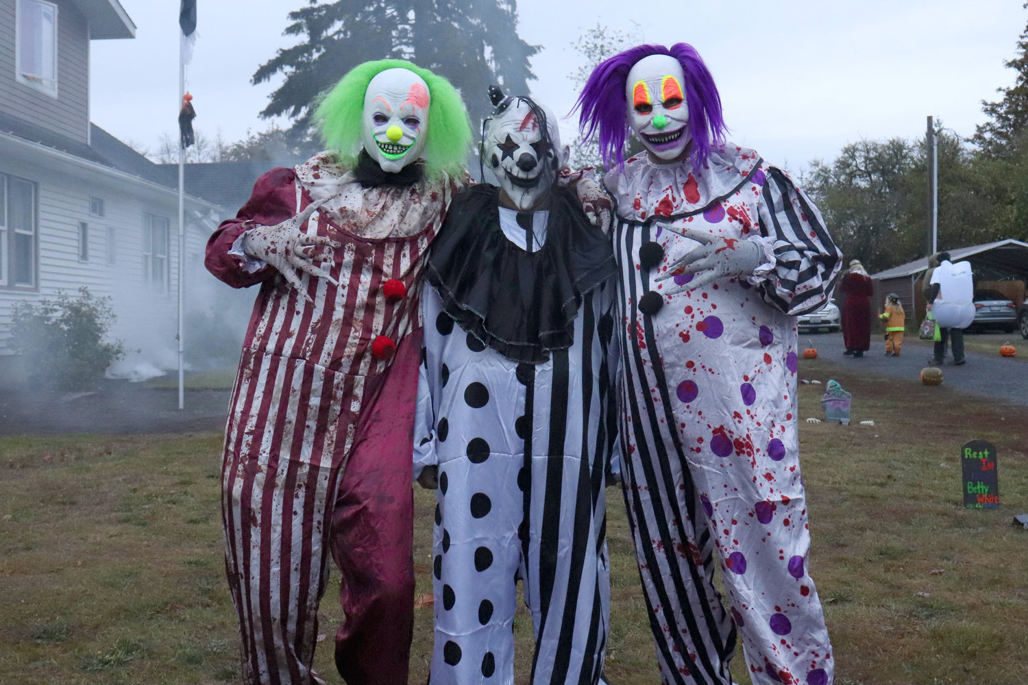 Clowns who entertained trick-or-treaters outside of 409 Second St. in Napavine pose for a photo Monday evening.