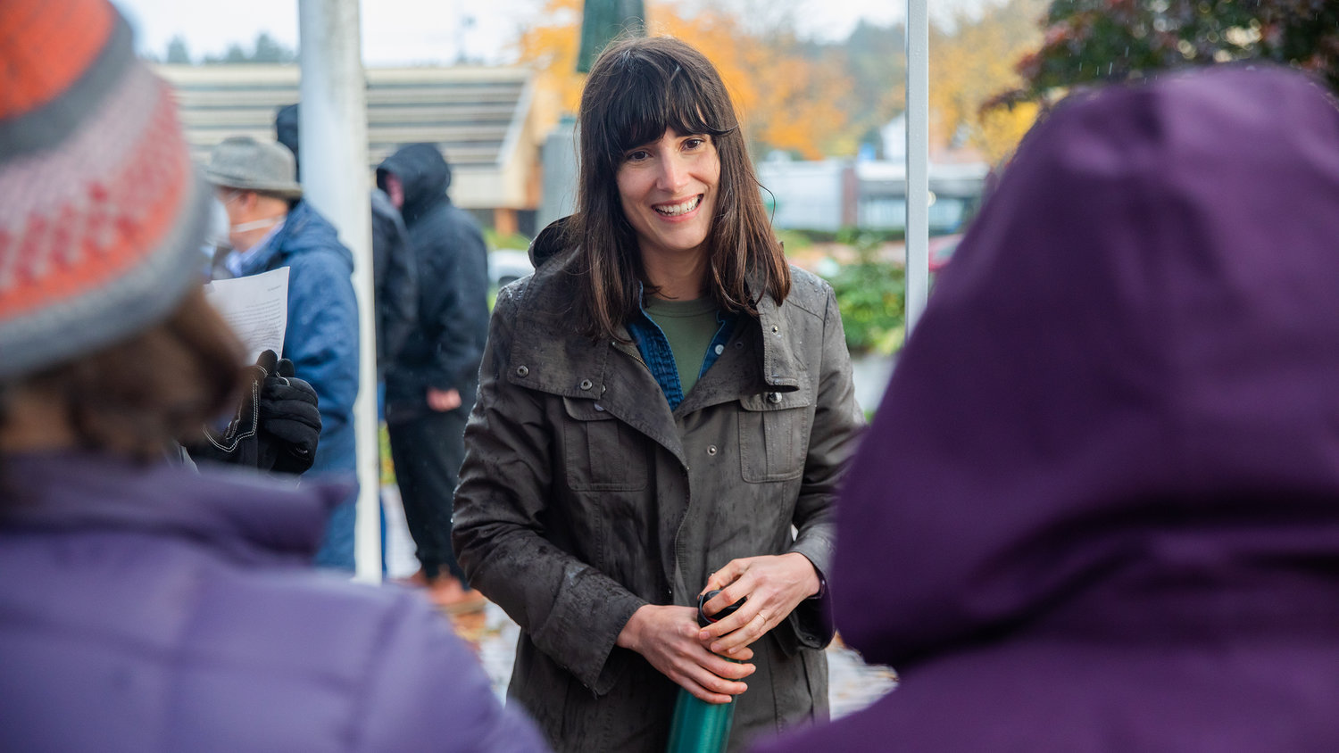 Marie Gluesenkamp Perez smiles while thanking supporters standing in the rain outside the Centralia Timberland Library on Saturday.