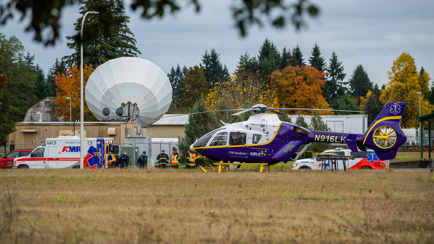 First responders are seen along Steelhammer Lane in Centralia as an Airlift Northwest helicopter lands to pick up a trauma patient before flying to Harborview Medical Center in Seattle.