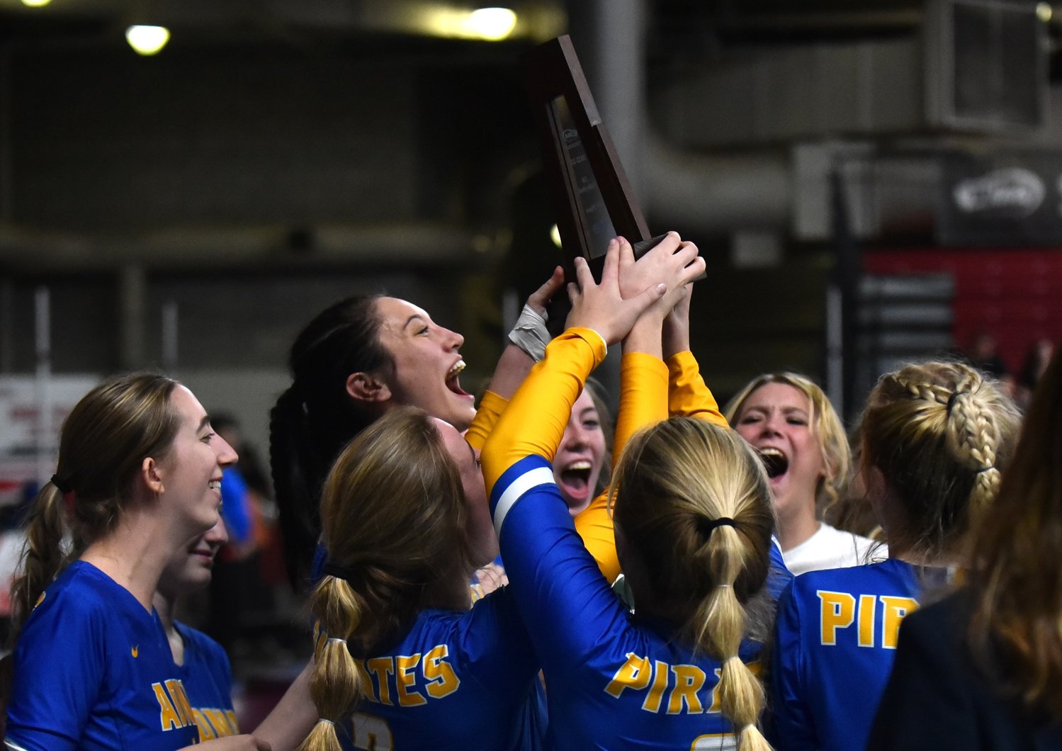 The Adna volleyball team celebrates with its trophy following its five-set win over Lind-Ritzville-Sprague-Washtucna-Harrington in the fifth-place game at the 2B state tournament on Nov. 11 in Yakima.