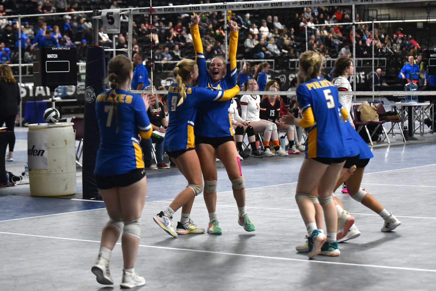 Danika Hallom (9), Kendall Humphrey (getting hugged), and the Adna Pirates celebrate a point during the fifth set of their win over Lind-Ritzville-Sprague-Washtucna-Harrington in the fifth-place game at the 2B state tournament on Nov. 11 in Yakima.