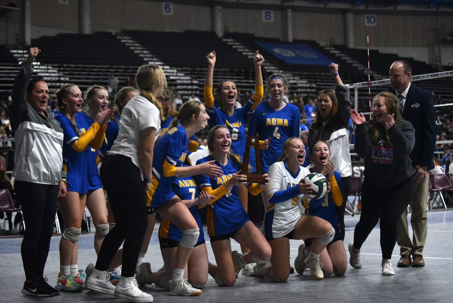 The Adna volleyball team celebrates after its five-set win in the fifth-place game at the 2B state volleyball tournament in Yakima on Nov. 11.