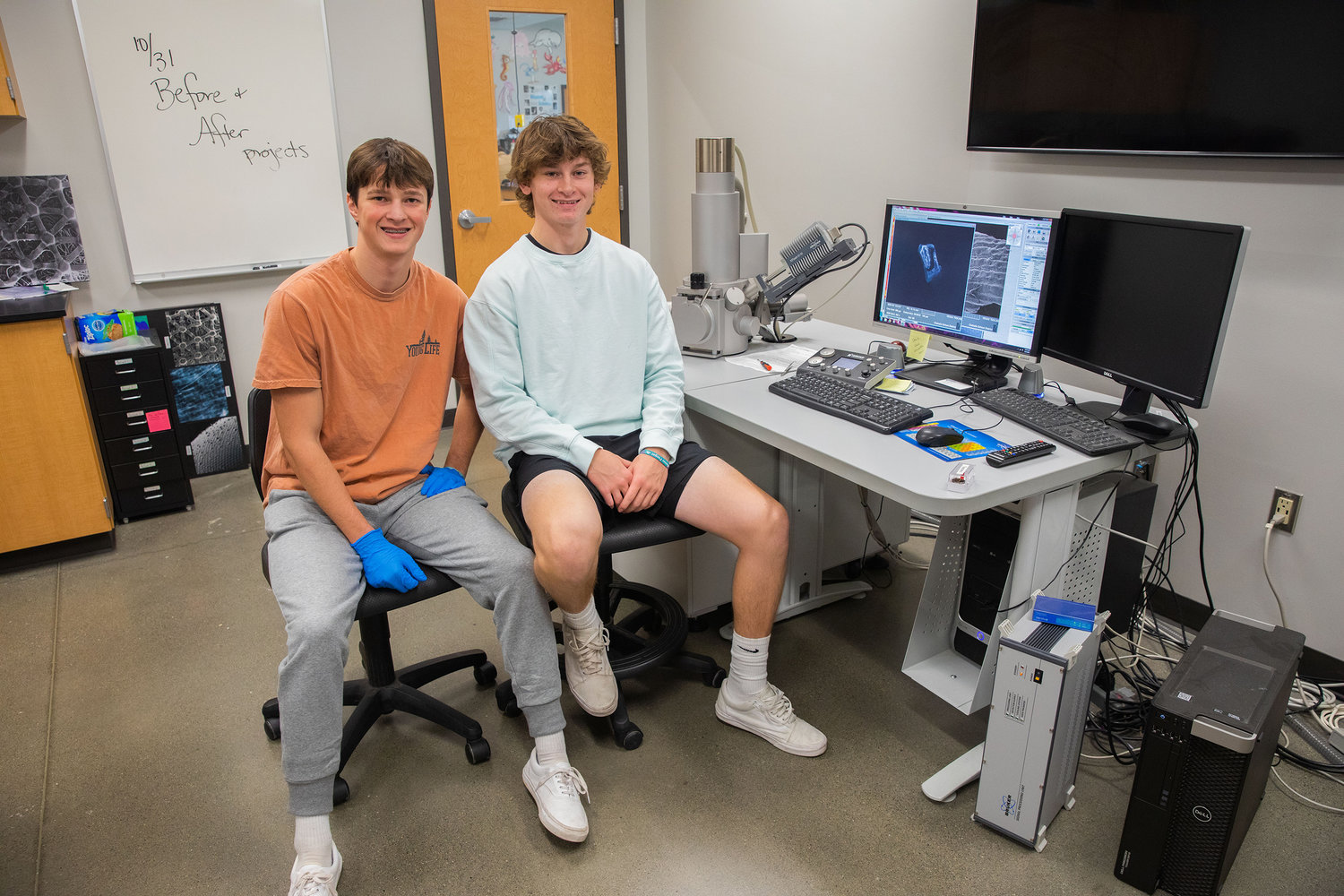 Ethan Klovdahl and Avery Staloch smile for a photo while working with a Scanning Electron Microscope at W.F. West on a Thursday morning in Chehalis.
