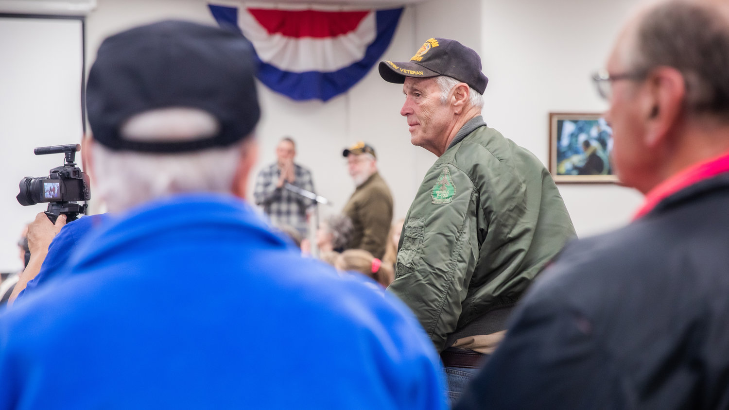 Air Force veterans stand to be recognized on Veterans Day during the 25th anniversary of the Veterans Memorial Museum in Chehalis.