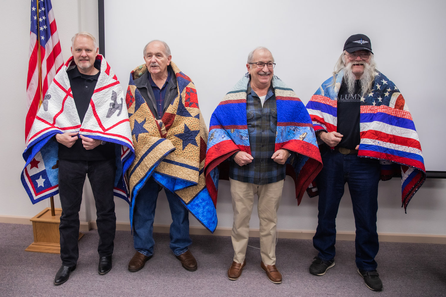 From left, Col. Patrick Taylor, Michael McCoy, Donald Schmidt and Joseph Bushlack smile for a photo after being presented with Quilts of Valor on Veterans Day during the 25th anniversary of the Veterans Memorial Museum in Chehalis.