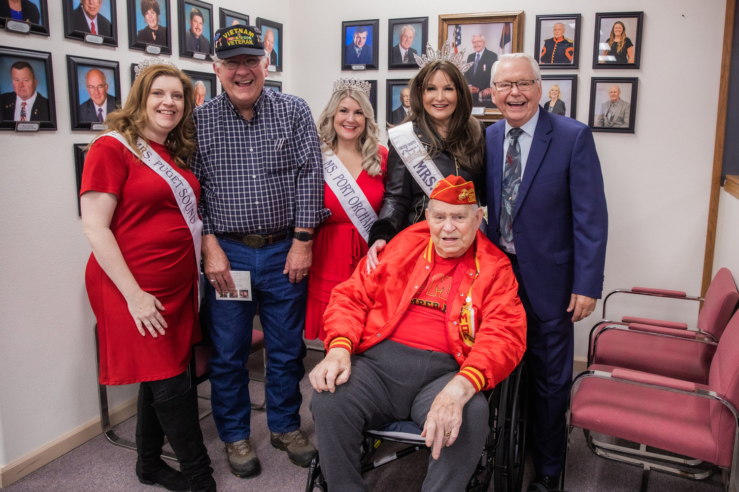 Bob Jordan and Jack Williams pose for a photo with Lee Grimes and Mrs. United States of America crowns on Veterans Day during the 25th anniversary of the Veterans Memorial Museum in Chehalis.