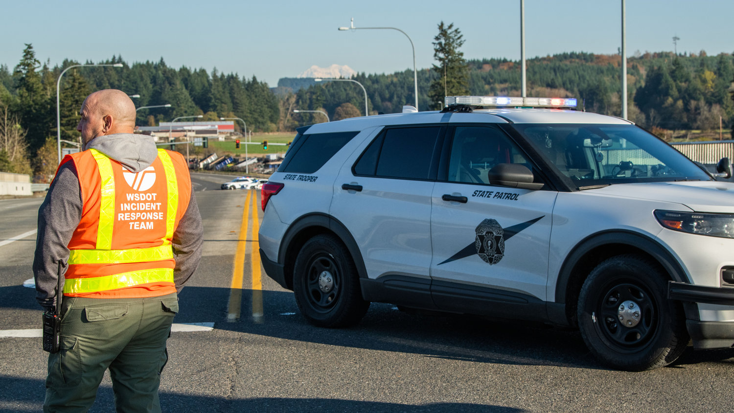 Incident Response Supervisor Shane Inman, with the Washington State Department of Transportation, watches as law enforcement investigates an officer involved shooting near Grand Mound on Monday.