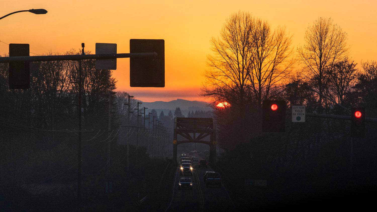 The sun sets over the Willapa Hills, illuminating the sky in an orange hue as seen from Chehalis Tuesday evening.