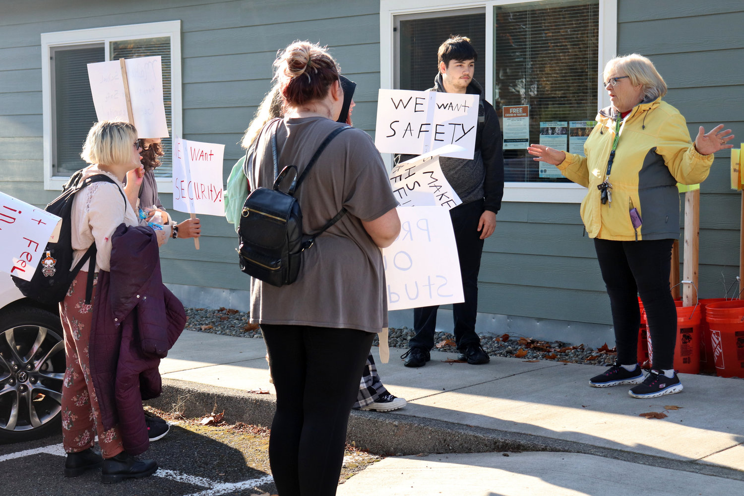 Centralia High School senior Dante Higgens stands beside his grandmother, Judy Anderson, at left, in front of the Centralia School District Administration Office during a protest over safety and security concerns on Thursday.