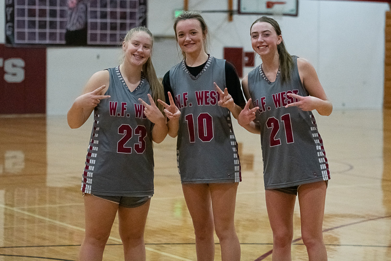 W.F. West players Carlie Deskins (23), Grace Simpson (10), and Morgan Rogerson (21) poses for a photo after practice Nov. 22.