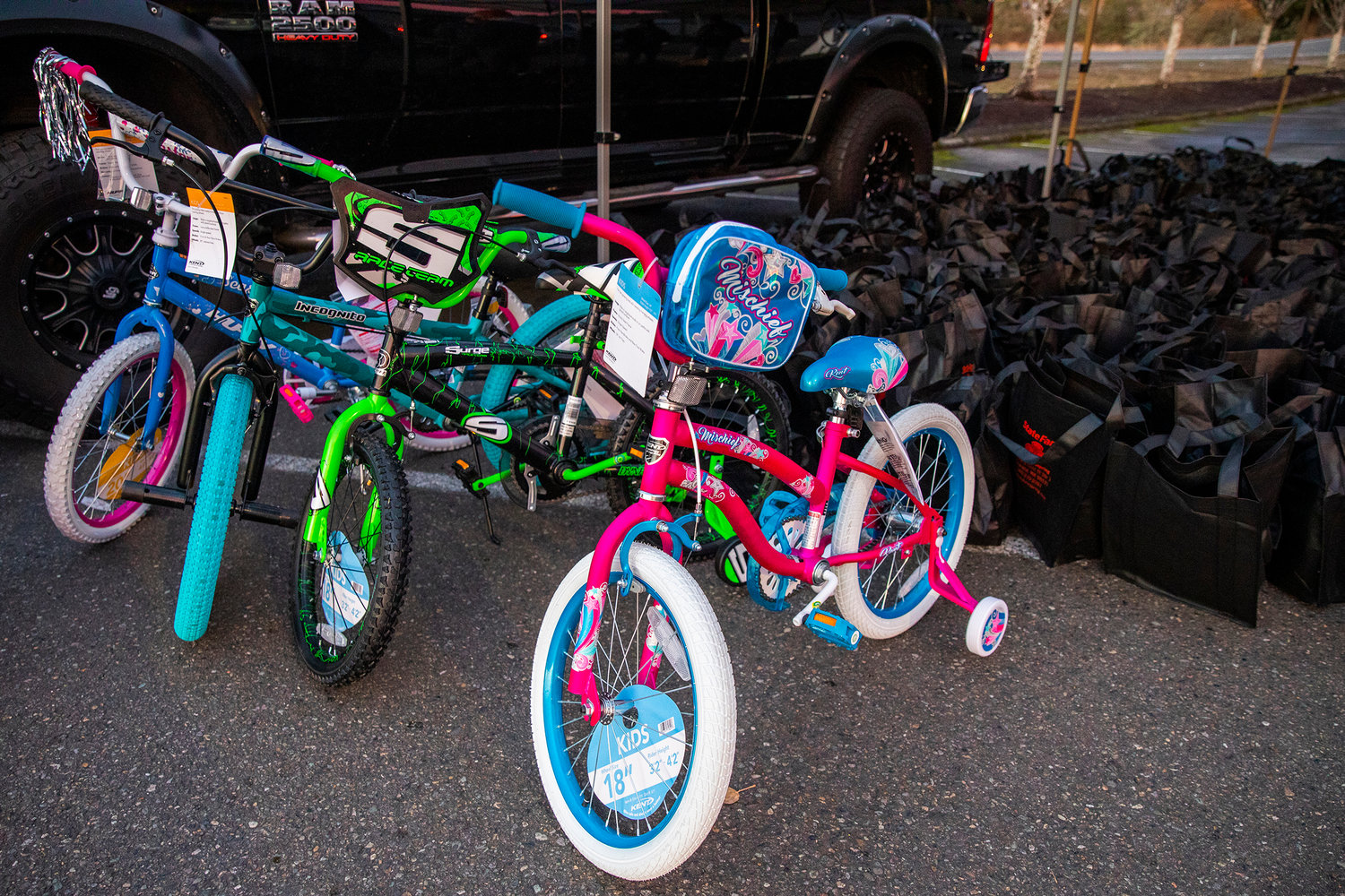 Four bikes sit on display for a “Choose Local Black Friday” giveaway hosted by the Centralia-Chehalis Chamber of Commerce Wednesday evening in the Lewis County Mall parking lot.