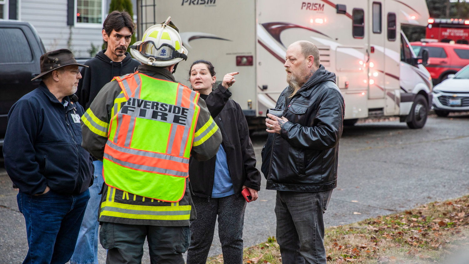 Stephanie Lane, a resident who lives in the building, talks with Chief Mike Kytta, of Riverside Fire Authority, following a residential fire in the 200 block of North Rock Street in Centralia on Friday.