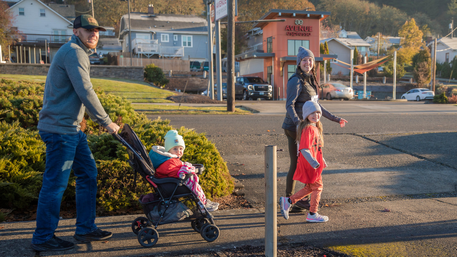 Families smile while jogging through downtown Chehalis Thanksgiving morning for the Turkey Trot 5K.