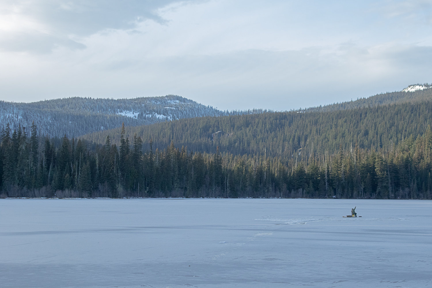A lone fisherman tries his luck on the frozen surface of Dog Lake just east of White Pass on Nov. 23.