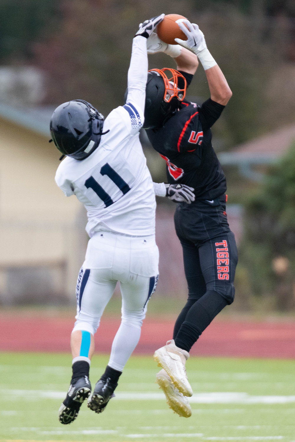 Karsen Denault out-jumps a Chewelah defender to come down with the ball during the second quarter of Napavine's 49-6 semifinal win over the Cougars on Nov. 26 in Tumwater.