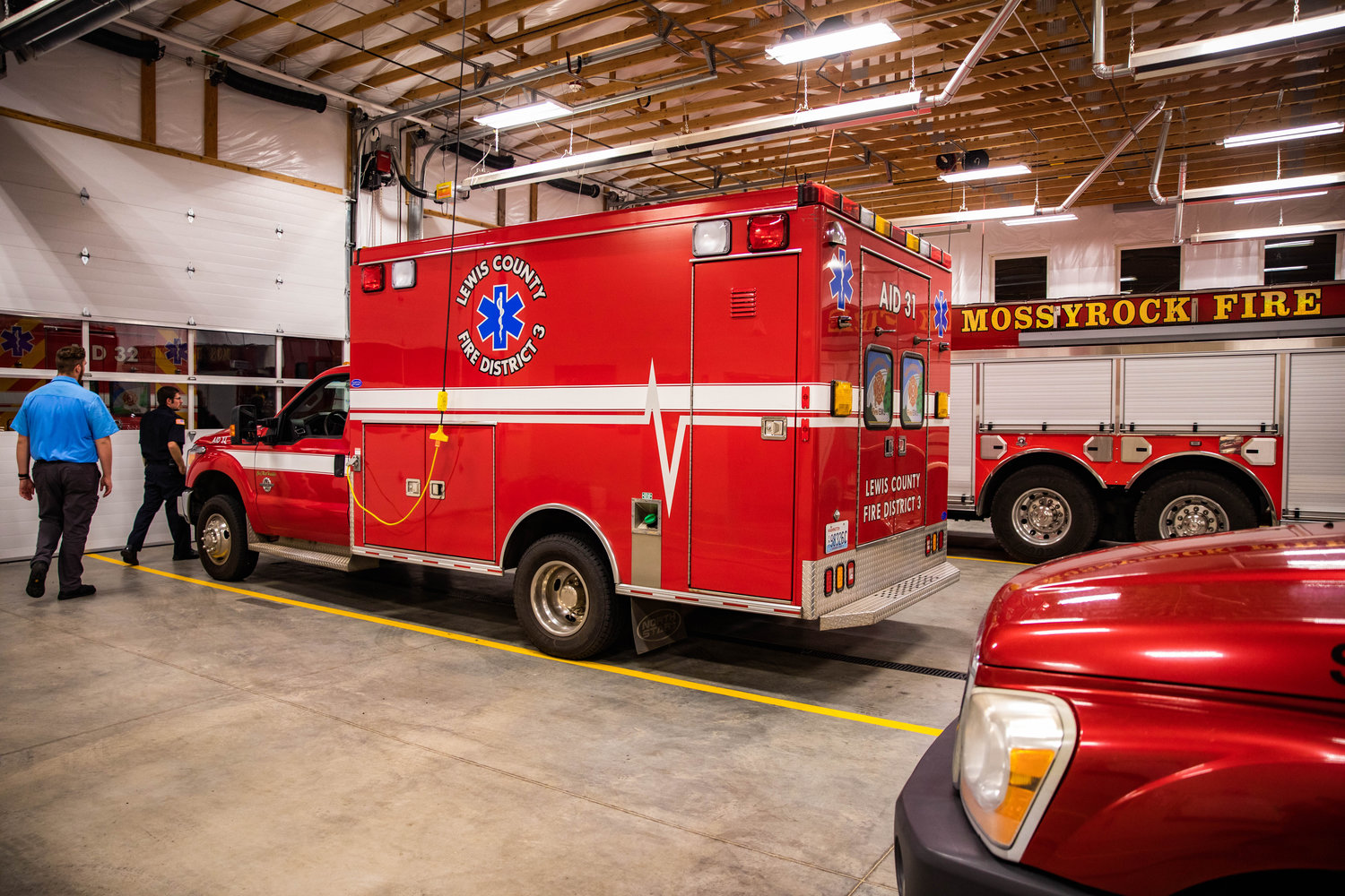 Ambulances and fire engines sit on display Monday night at the Lewis County Fire District 3 building in Mossyrock.
