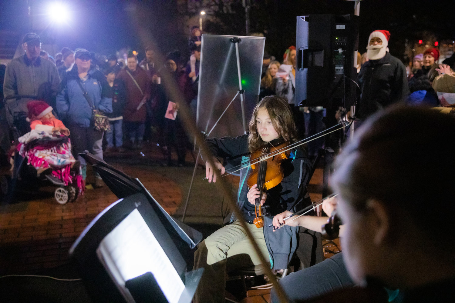 Members of the Centralia High School and Centralia Middle School orchestra bands perform “Jingle Bells,” Friday night at George Washington Park before a Christmas Tree Lighting celebration.