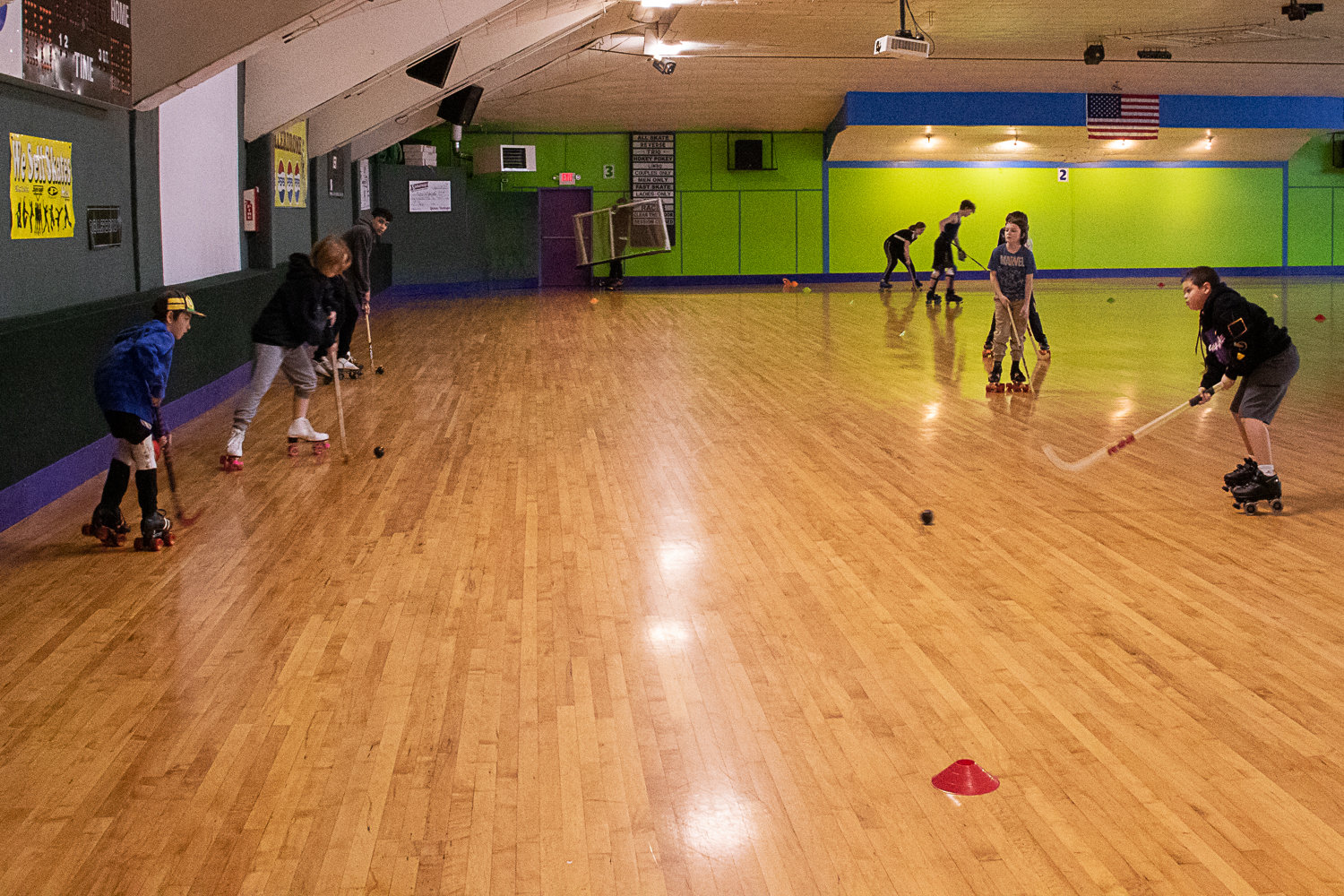 Members of the Centralia Sharks rollerhockey club work on passing drills at the Centralia Rollerdome.