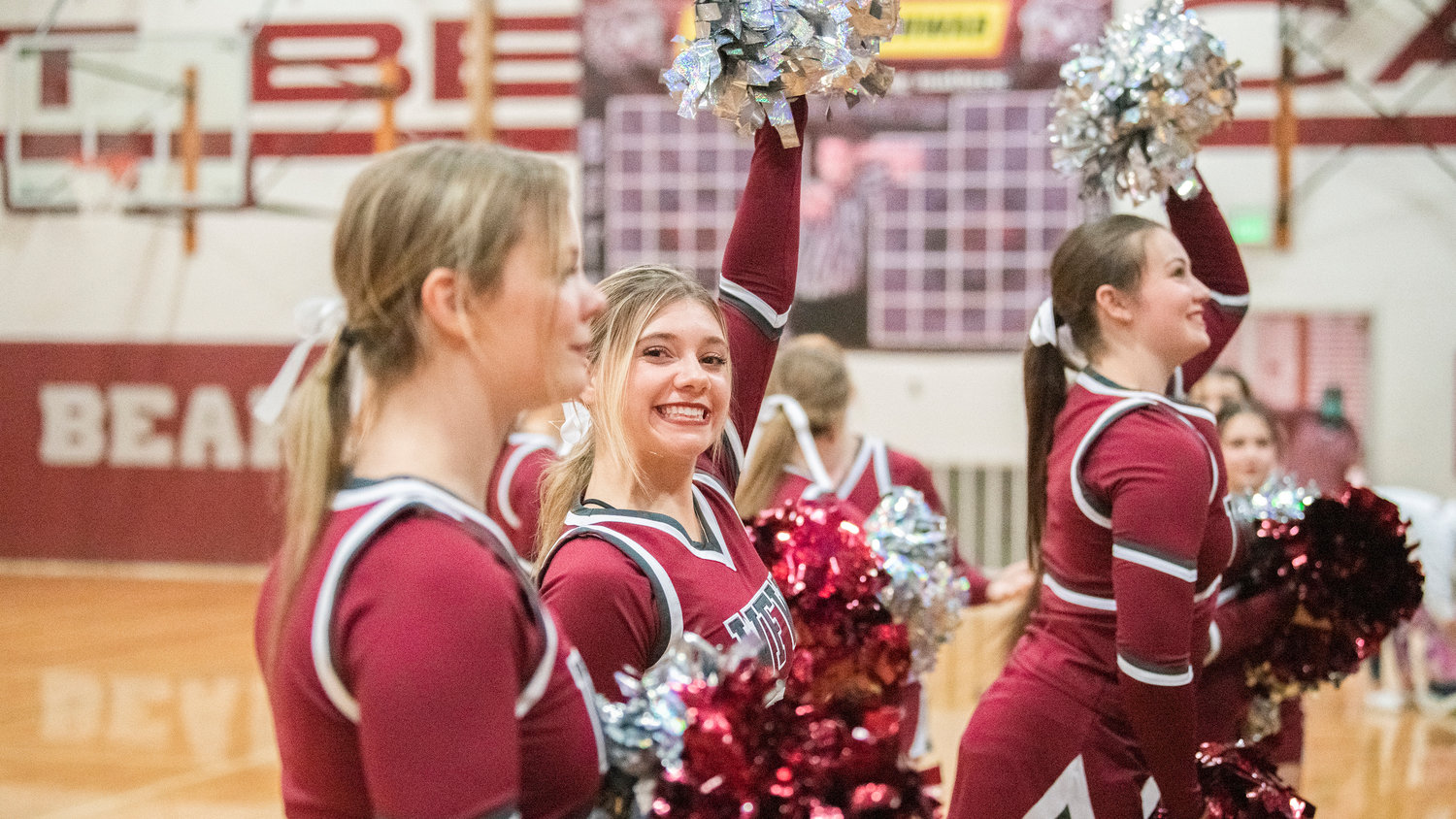 Bearcat cheerleaders smile and raise their pom-poms during a basketball game in Chehalis Tuesday night.