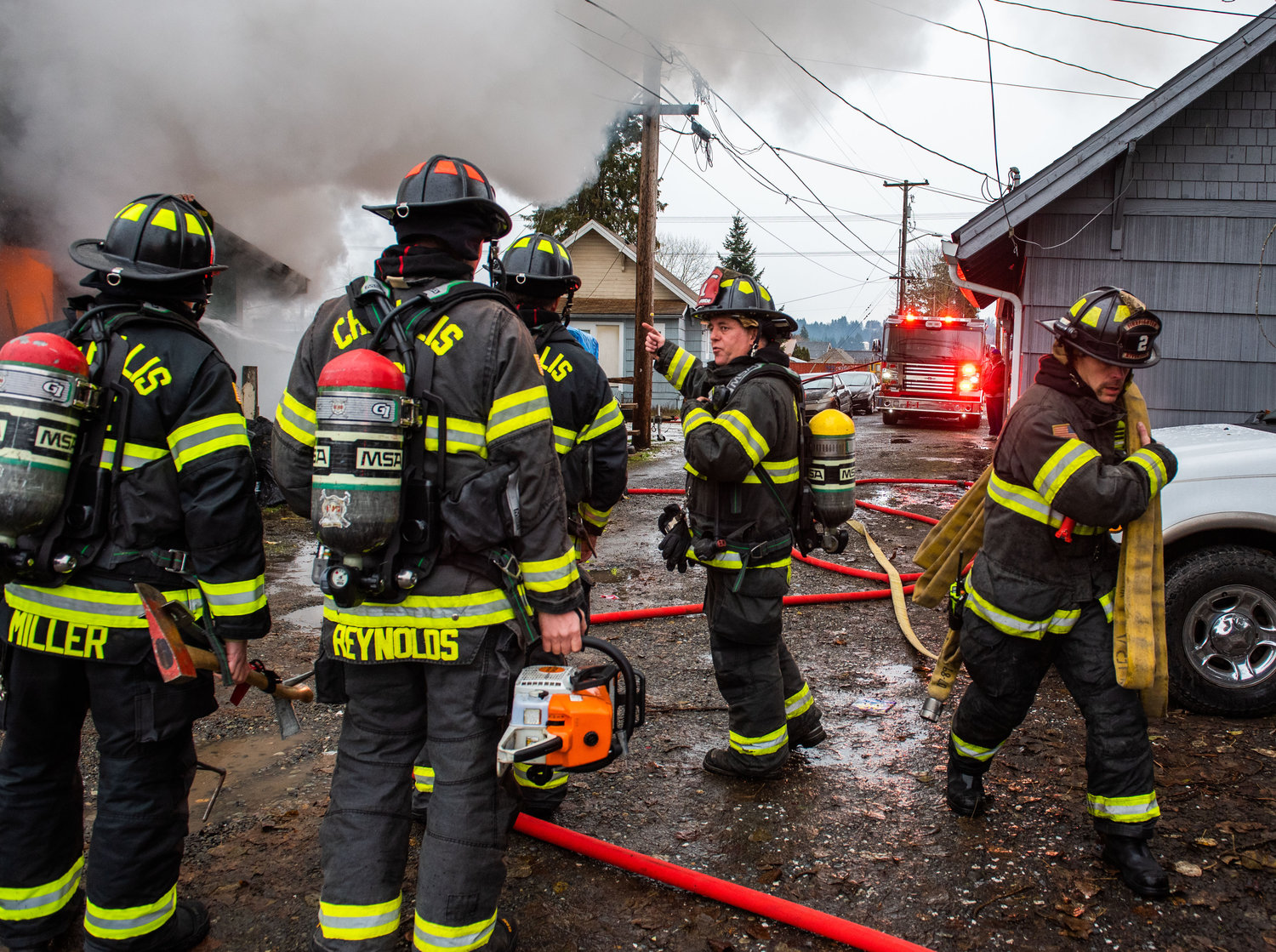 Captain Casey McCarthy, with Riverside Fire Authority, directs crews as they respond to a residential structure fire off W. Main Street in Centralia on Sunday.