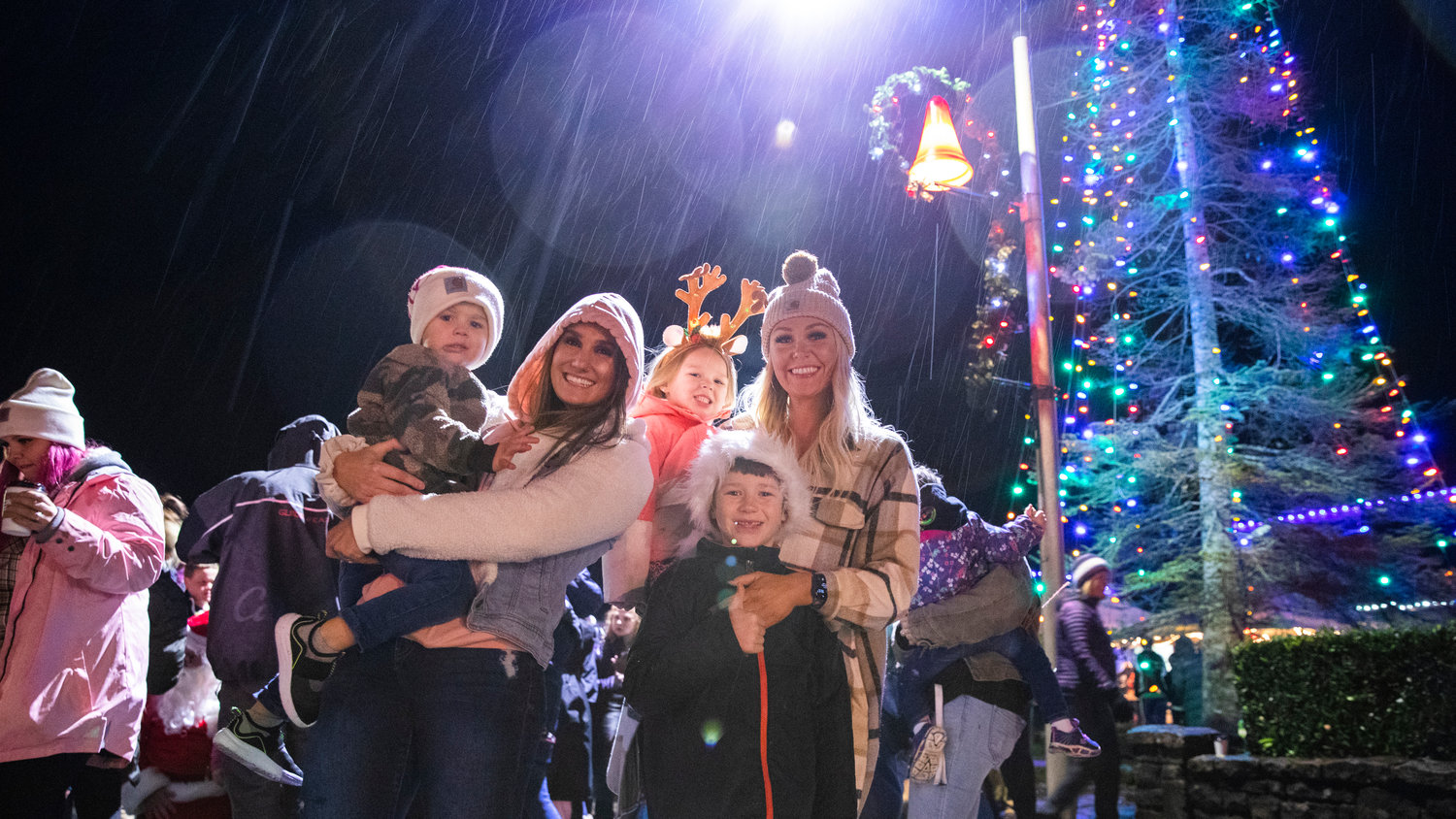 Members of the Jensen and Johnson families gather for a photo in front of the Christmas tree in downtown Tenino Friday night. It was the 35th annual Tenino Christmas Tree Lighting in the Stone City.  The event was brought to the community by the Tenino Area Chamber of Commerce.