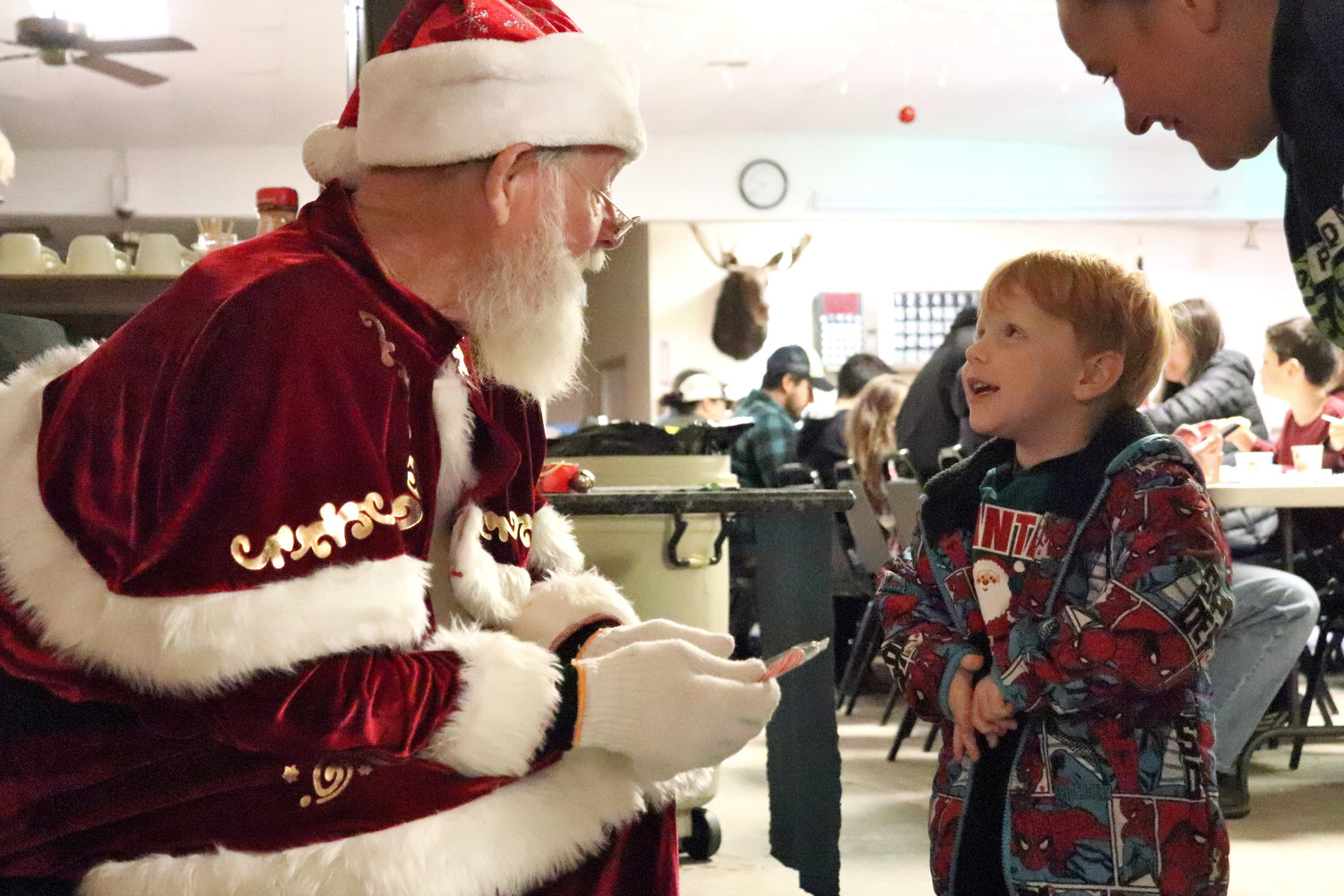 Three-year-old Ryan talks to Santa during a Breakfast with Santa event at the Moose Family Center in Centralia on Saturday.