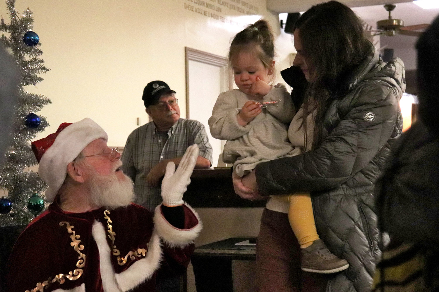 Santa blows a kiss to one-year-old Rylynn during a Breakfast with Santa event at the Moose Family Center in Centralia on Saturday.