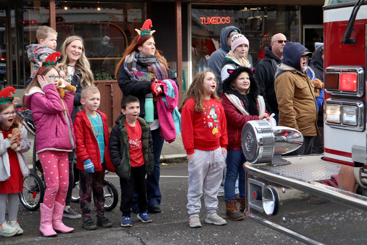 Kids react to an engine from the Chehalis Fire Department sounding its sirens during the Santa Parade in downtown Chehalis on Saturday.