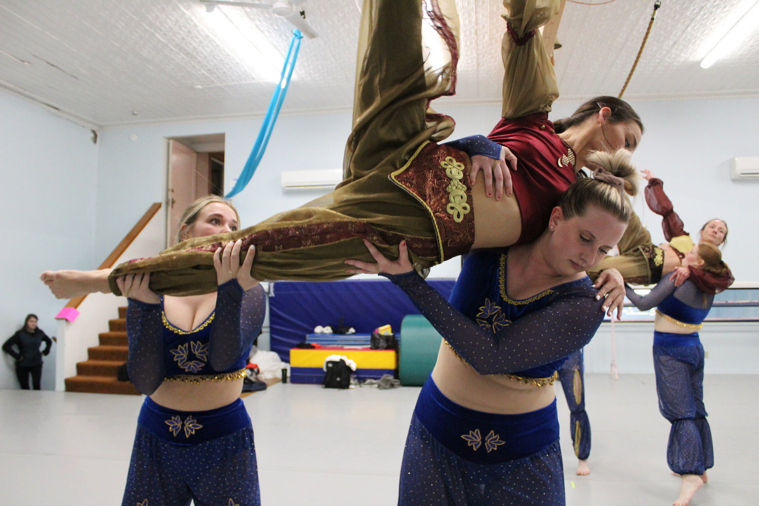 Erin Jennings and Christina Hill lift Arabian princess Myah O'Neill during a rehearsal for the Arabian Corps portion of "The Nutcracker Ballet." This year's Arabian Corps dance features an all-female cast of dancers.