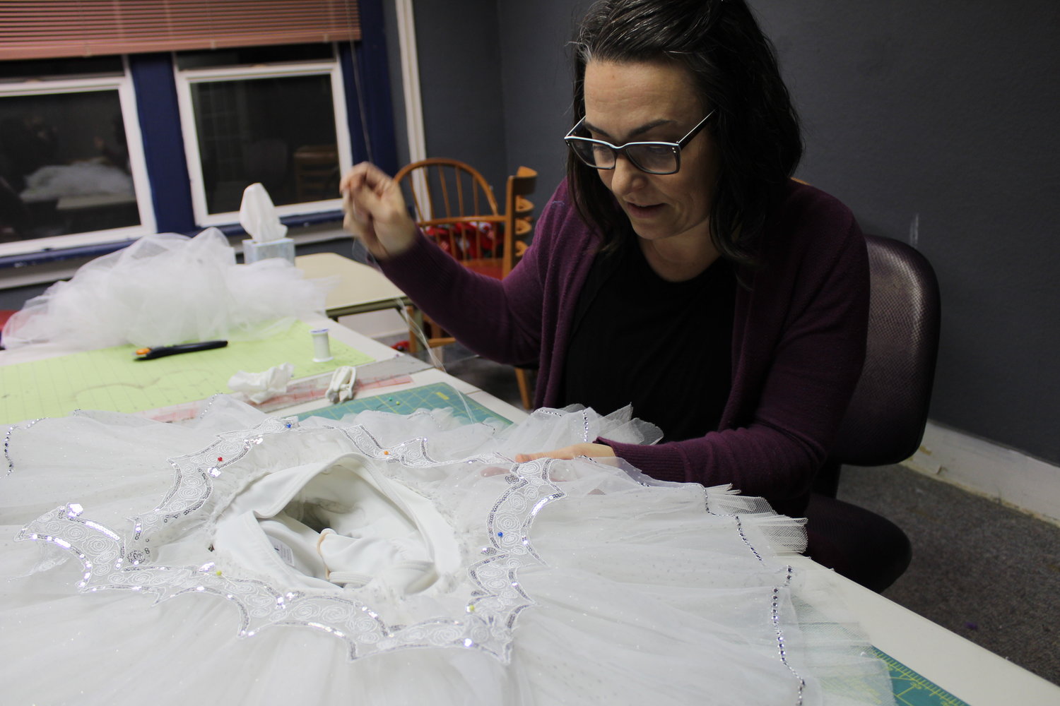 Tiffany James adds embellishments to a costume for Snow for "The Nutcracker” presented by Southwest Washington Ballet. For the 25th anniversary celebration, the Chehalis dance school has revived some vintage costumes and set pieces to pay homage to the performance's history.