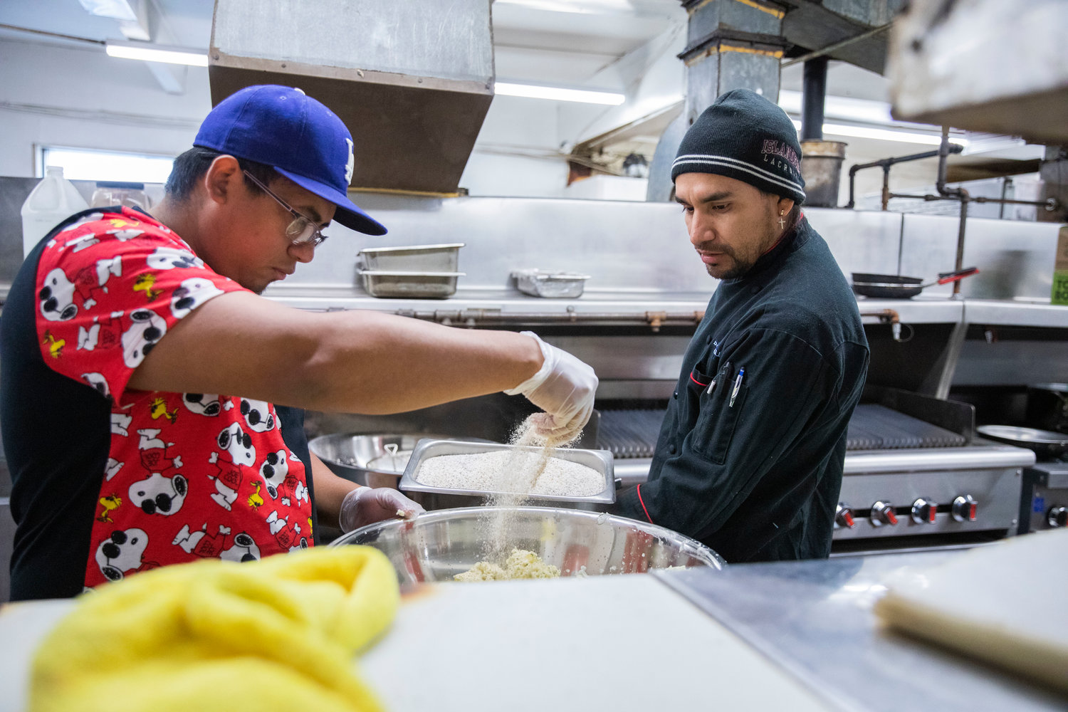 Owner and Head Chef Eyner Cardona supervises as Daniel Flores adds herbs and seasoning to mashed potatoes at Ocean Prime Family Restaurant in Chehalis Monday morning.