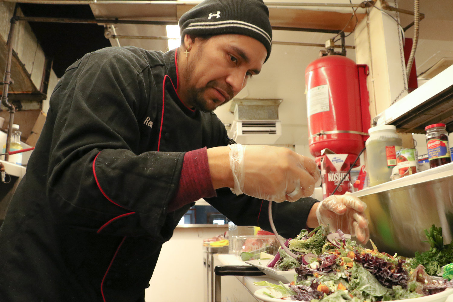 Chef Eyner "Rene" Cardona garnishes bleu cheese salads for a sampling of the menu at his new restaurant in Chehalis, Ocean Prime, on Monday morning.
