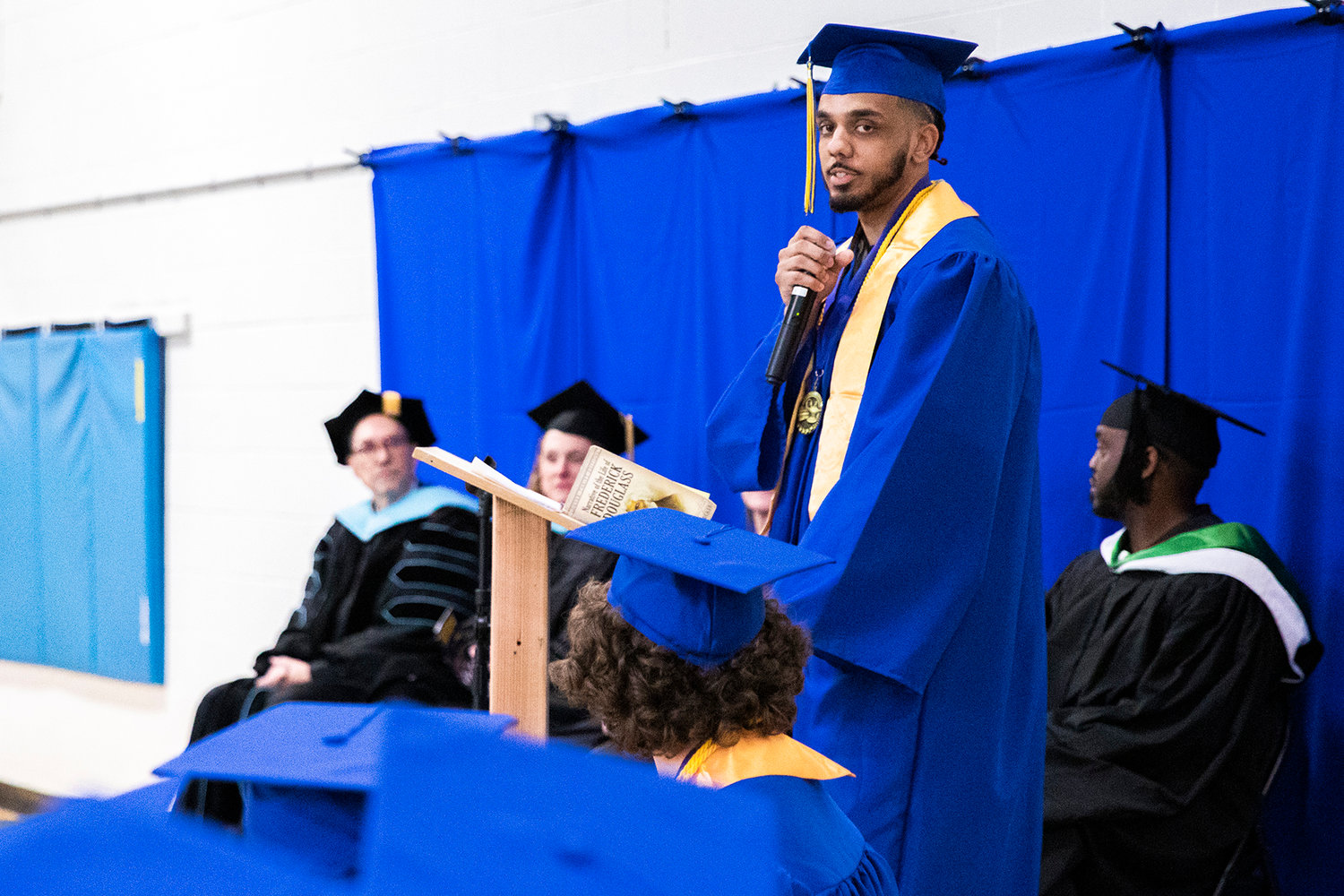 Rodney Strickland reads a quote from Nelson Mandela during his speech at a graduation ceremony for Centralia College graduates held at the Green Hill School on Wednesday in Chehalis.