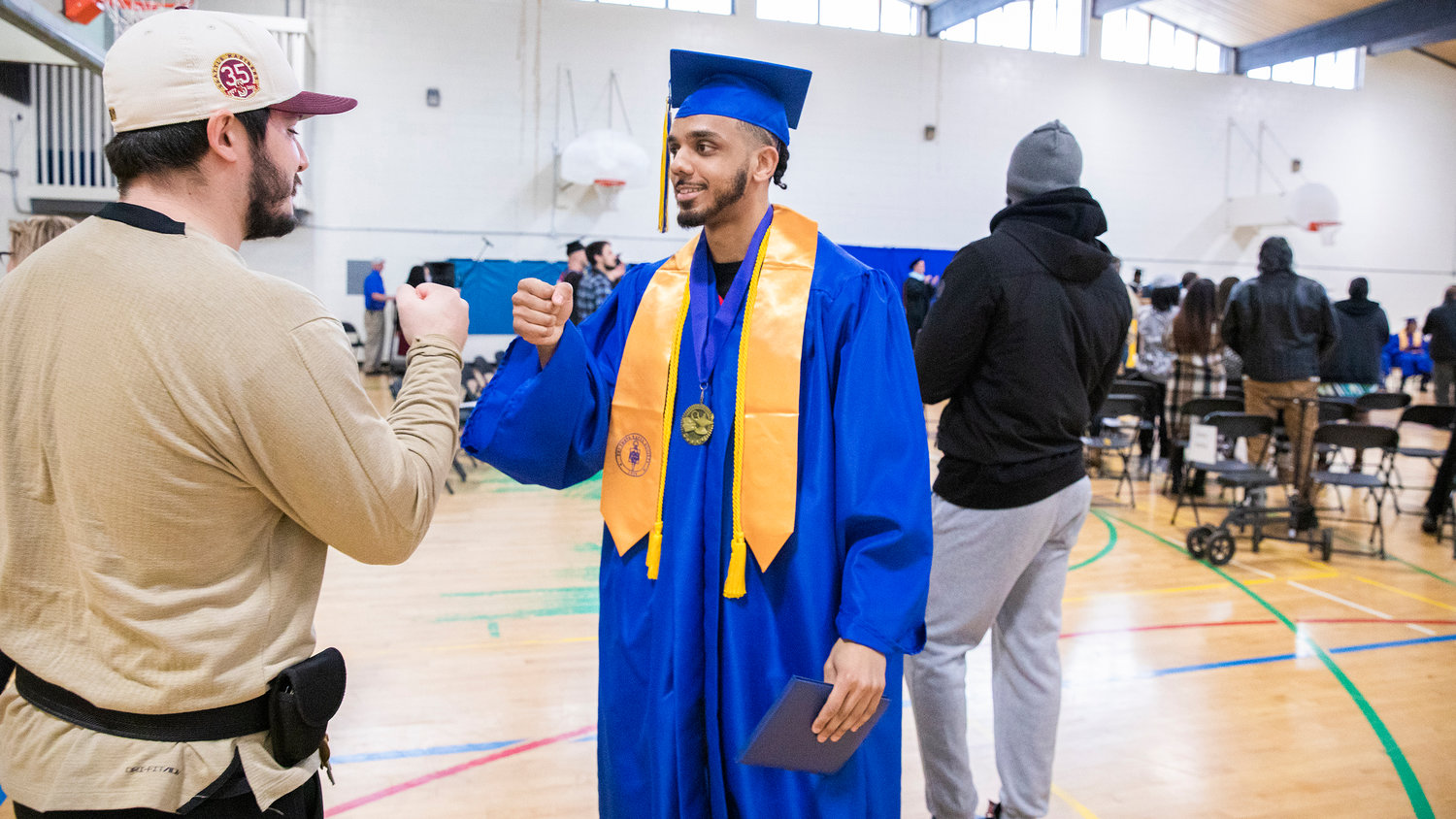 Rodney Strickland smiles and receives fist-bumps after getting his diploma on stage during a graduation ceremony for Centralia College graduates held at the Green Hill School on Wednesday in Chehalis.