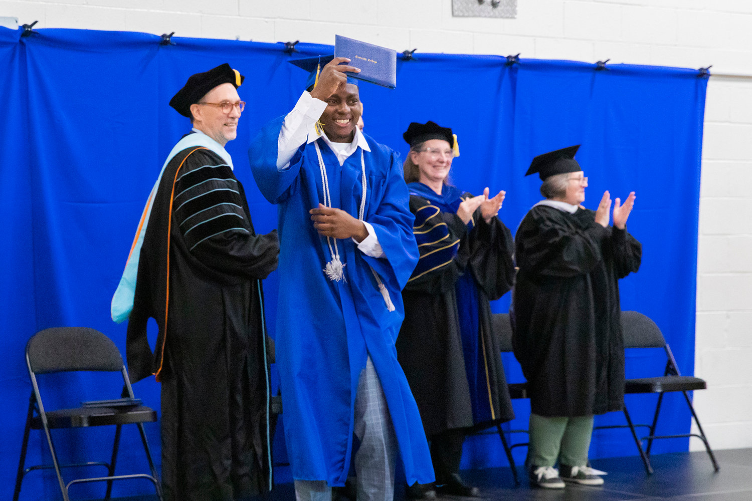 Lakendrick Butts smiles and holds up his diploma while dancing on stage during a graduation ceremony for Centralia College graduates held at the Green Hill School on Wednesday in Chehalis.
