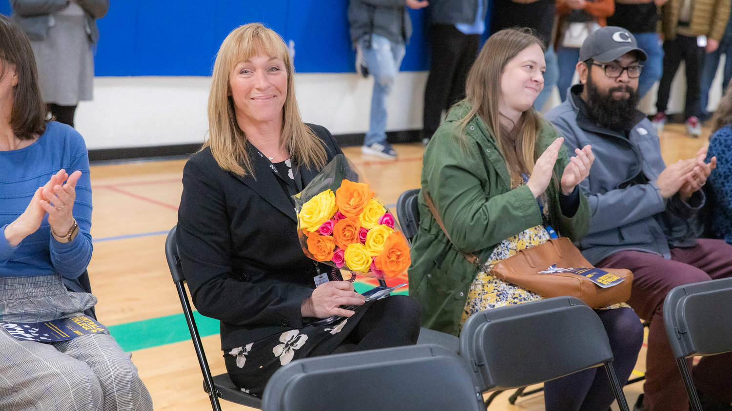 Green Hill Superintendent Jennifer Redman smiles for a photo after being honored with flowers during a graduation ceremony for Centralia College graduates on Wednesday in Chehalis.