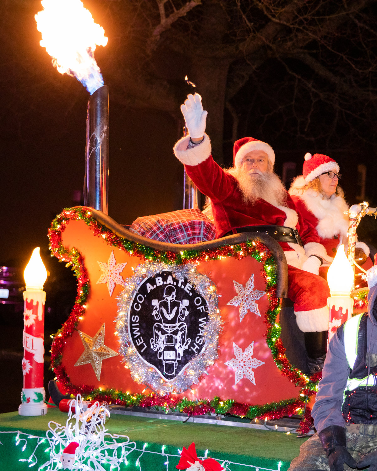 Santa waves as flames burst from the Lewis County A.B.A.T.E (A Brotherhood Against Totalitarian Enactments) float Saturday night in downtown Centralia.