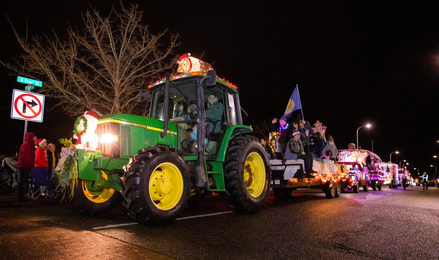 Pigs illuminate a John Deere tractor as crowds gather for the Lighted Tractor Parade Saturday night in downtown Centralia.
