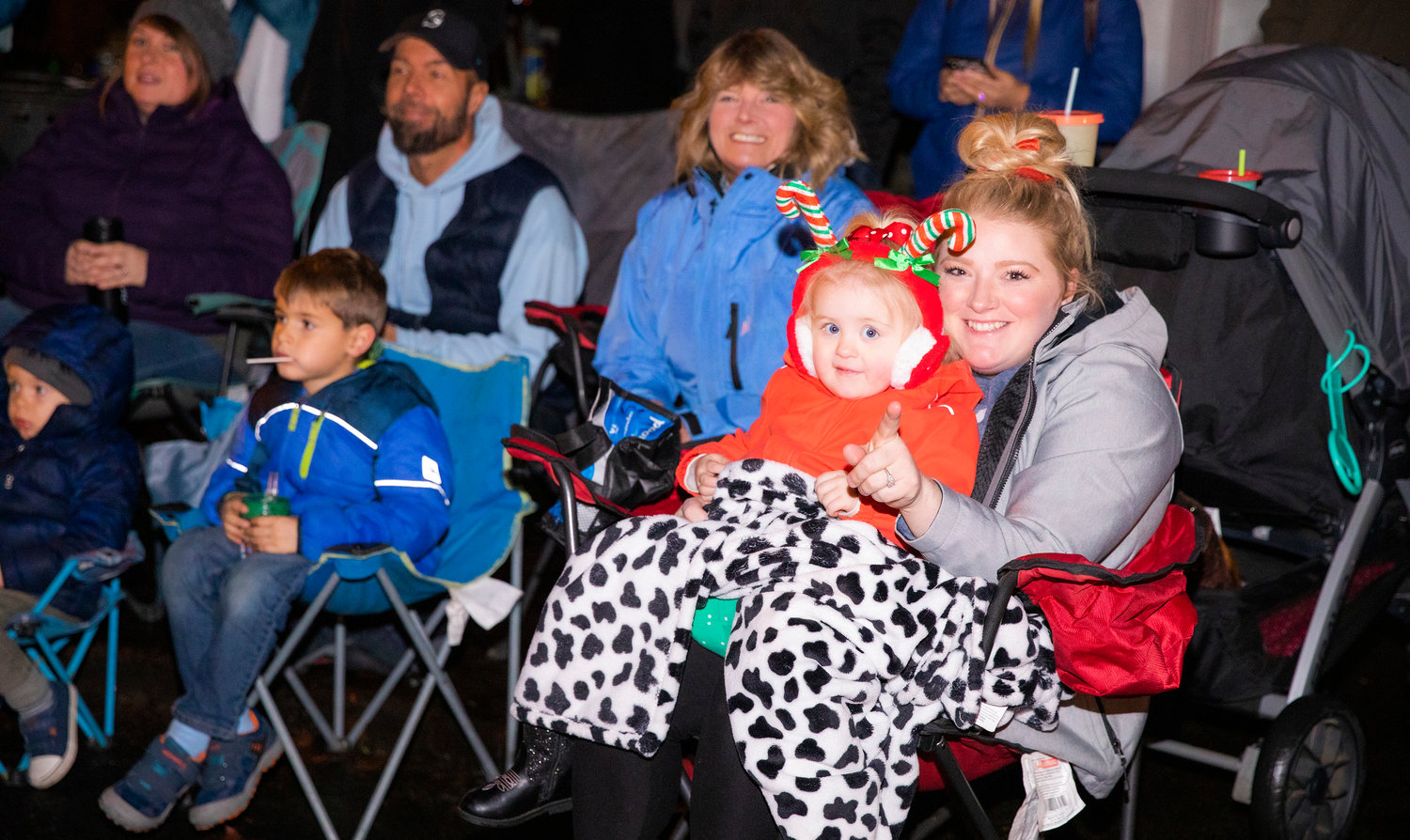 Kennedy, 3, and Brandi Brantley smile and watch the Lighted Tractor Parade Saturday night in downtown Centralia.