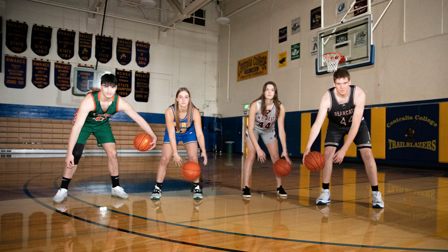 From left, MWP’s Josh Salguero, Adna’s Karlee VonMoos, and W.F. West’s Juila and Soren Dalan dribble basketballs and pose for a photo in the Centralia College gymnasium on Tuesday.