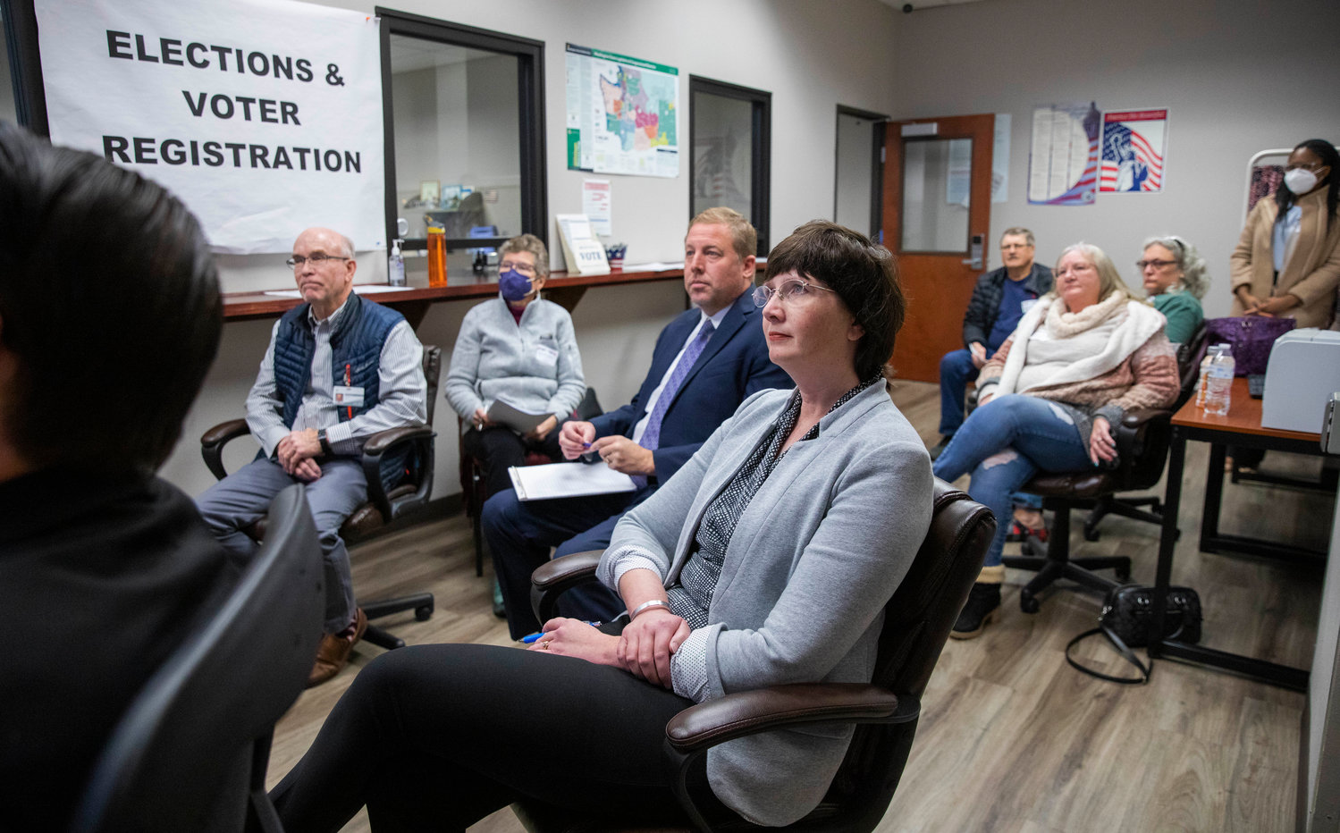 Commissioner Lindsey Pollock is joined by Auditor Larry Grove and other observers during a machine recount of votes Friday morning in Chehalis.