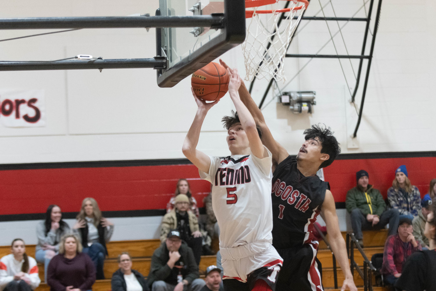 Noah Schow goes up to the rim past a defender during the first quarter of Tenino's game against Ocosta on Dec. 21.