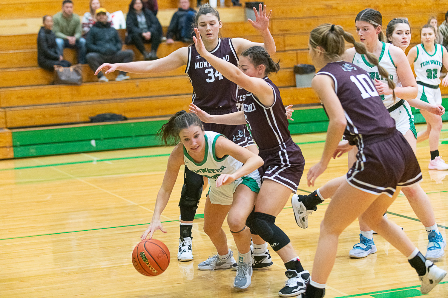 Regan Brewer is trapped under the basket by three Montesano defenders during the first quarter of Tumwater's 37-21 loss to the Bulldogs on Dec. 22.