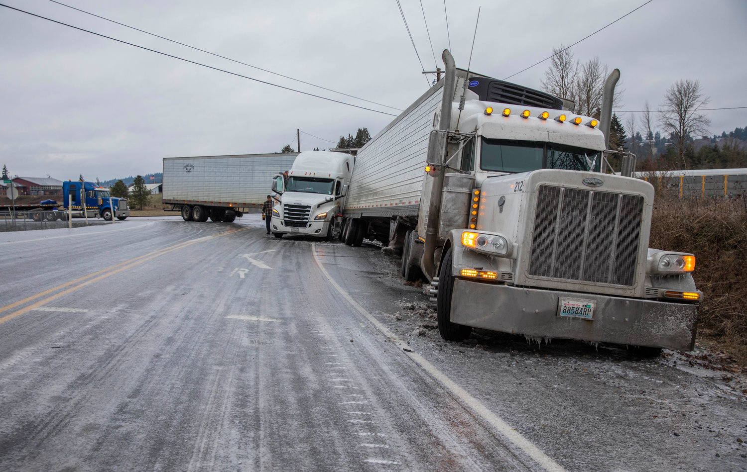 Semi trucks block lanes of SW Interstate Ave. and Bishop Rd. in Chehalis on Friday.