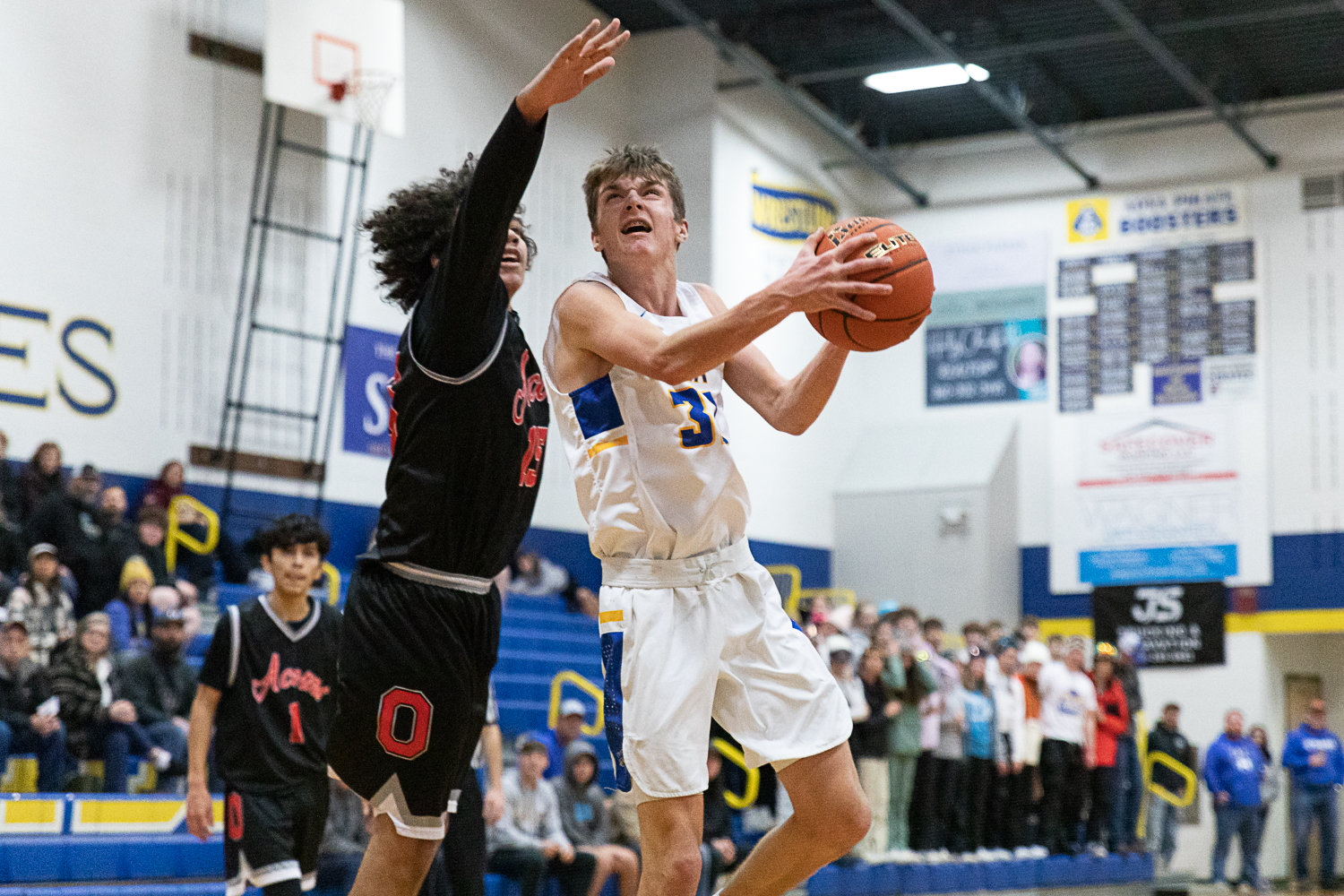 Adna guard Seth Meister drives for a layup against Oakville Dec. 27.