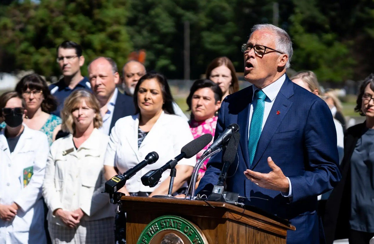 Gov. Jay Inslee is surrounded by legislators and reproductive health experts and advocates during a press conference responding to the Supreme Court’s decision in Dobbs v. Jackson Women’s Health Organization in June. This photo was provided by the governor’s office.