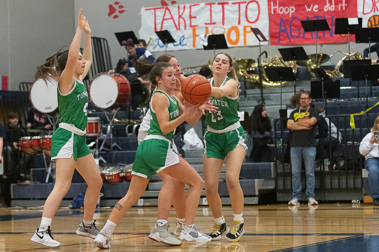 Regan Brewer and Sydney Sumrok team up to strip the ball off of Black Hills' Carmen Williams during the second half of Tumwater's 42-21 win over the Wolves on Jan. 6.