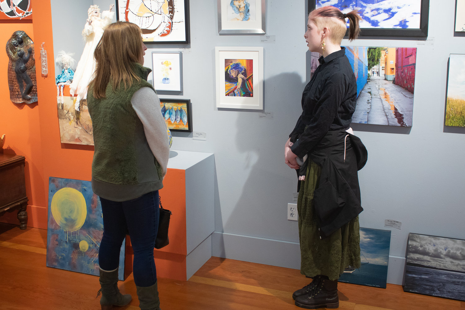 Toledo High School sophomore Kaycee Horrace talks a gallery viewer through her work currently on display for the next month at the Rectangle Gallery & Creative Space.